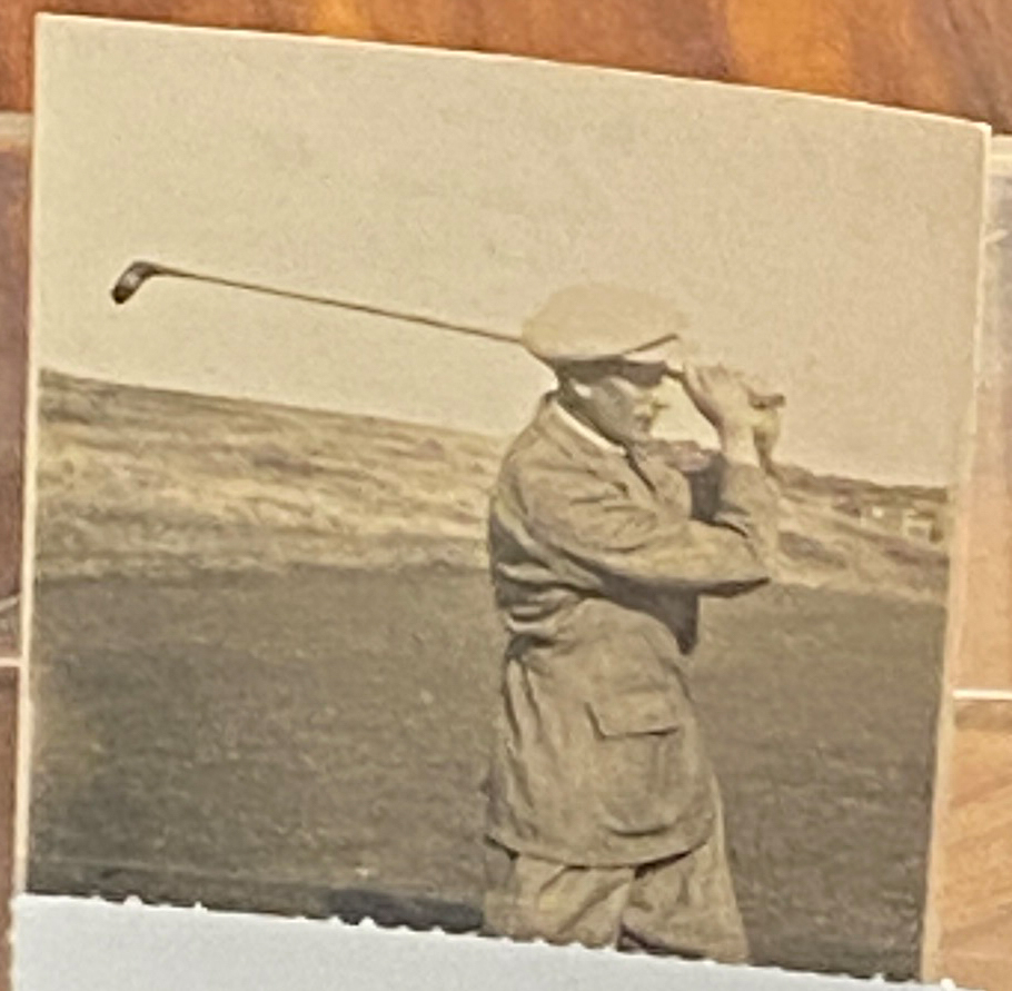A snapshot of Greenkeeper George Lowe mid-swing